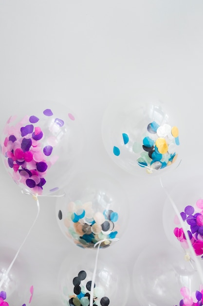 Bottom view transparent balloons with confetti inside