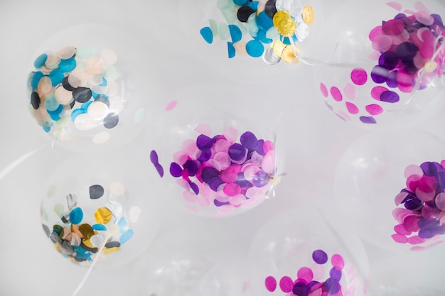 Bottom view transparent balloons with confetti inside