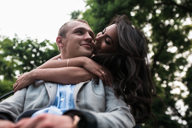 Bottom view of woman embracing her boyfriend