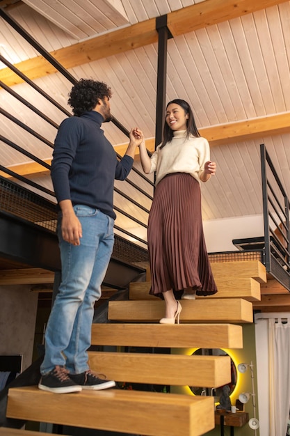 Bottom view of woman going down stairs to man