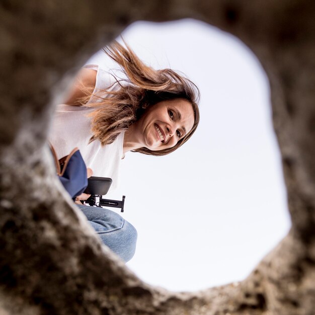 Bottom view woman looking at a hole