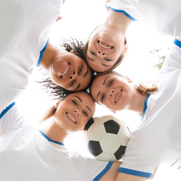 Bottom view women holding ball close-up