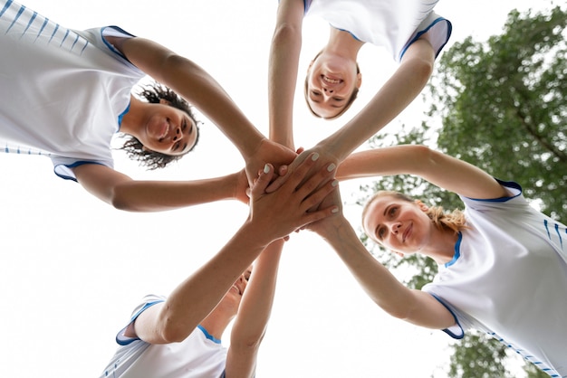 Bottom view women holding hands