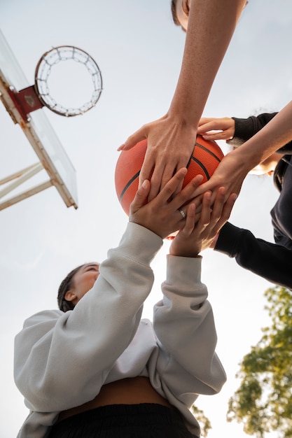 Free photo bottom view women playing basketball