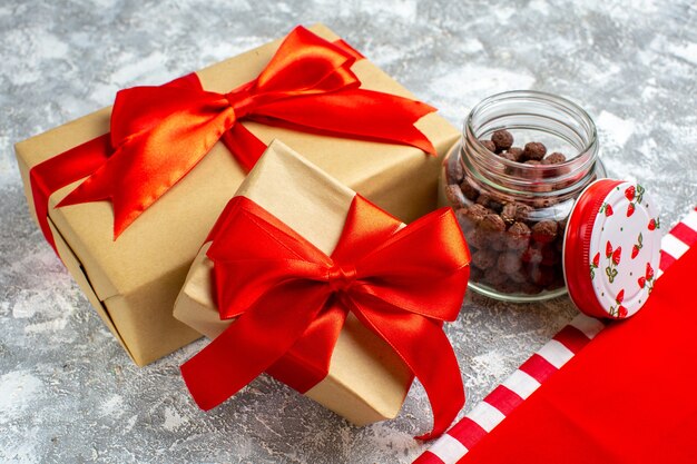 Bottom view xmas gifts cereal in jar red tablecloth on grey background