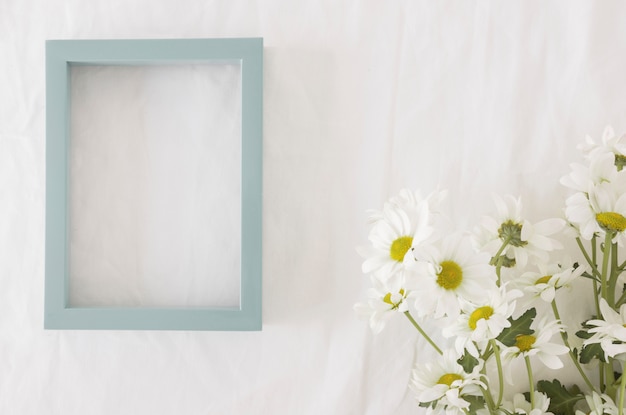 Bouquet of beautiful flowers on green stems near frame