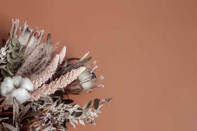 Bouquet of dried wildflowers, cotton and leaves flat lay.