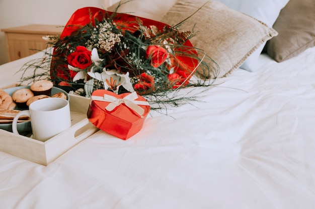 Bouquet and heart box near tray 