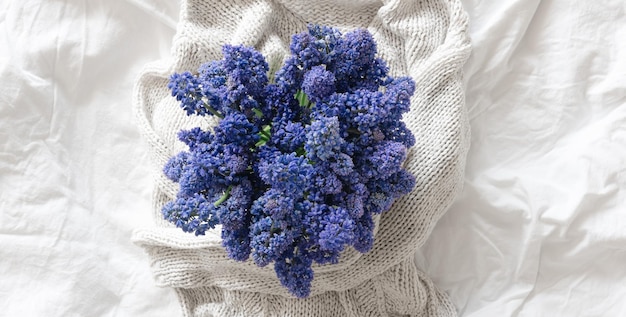 Free photo bouquet of lilac flowers in a white bed top view