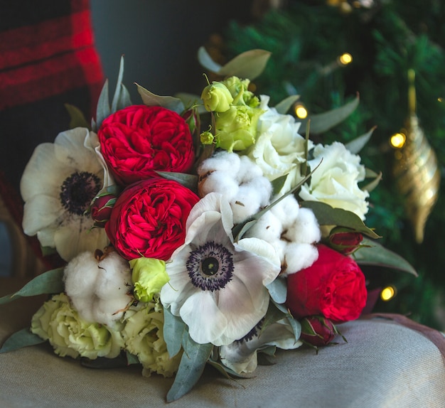 A bouquet of mixed flowers on the furniture.