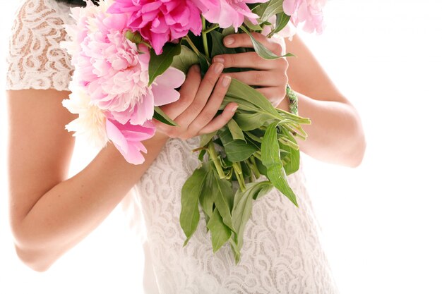 Bouquet of peonies in woman's hands