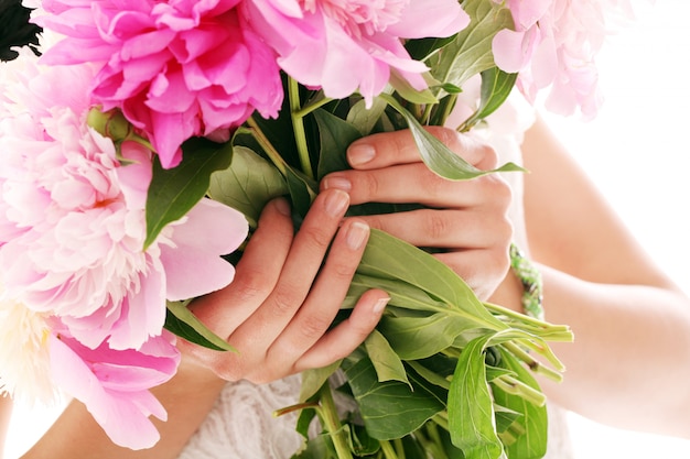 Bouquet of peonies in woman's hands