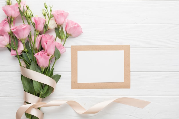 Bouquet of pink roses with ribbons and copy space