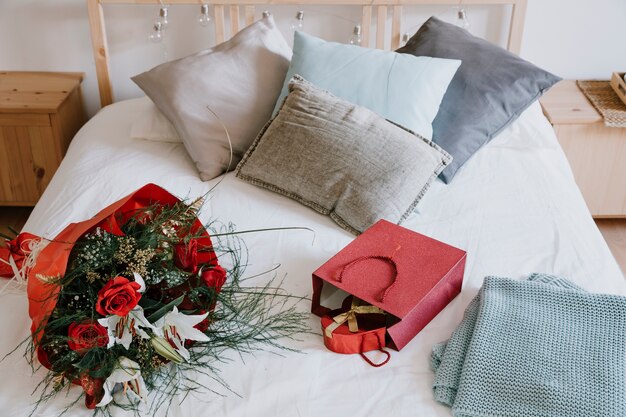 Bouquet and presents on bed