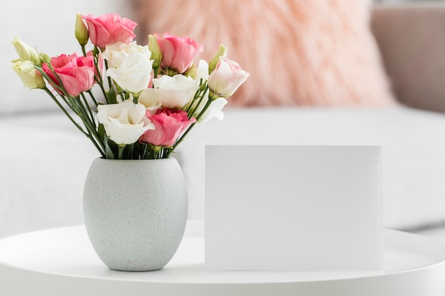 Bouquet of roses in a vase next to empty card