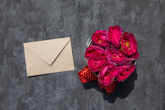 Bouquet of roses with white envelope