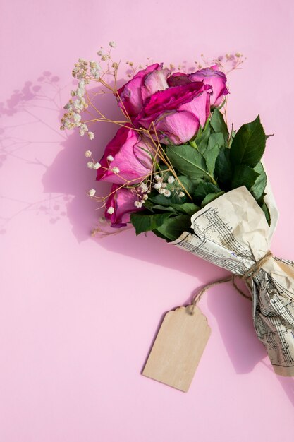 Bouquet of roses wrapped in music sheet