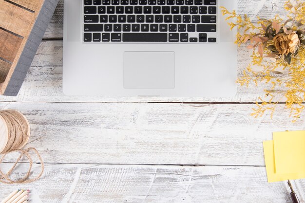 Bouquet and stationery on table near laptop