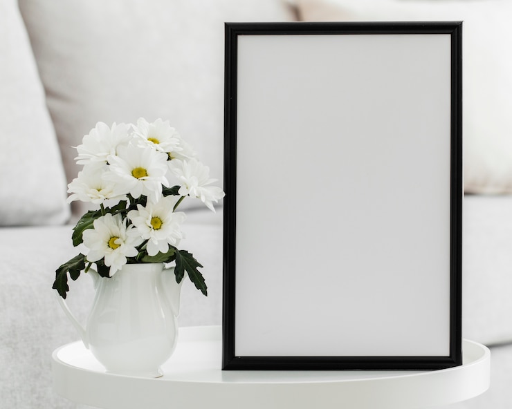 Free Photo bouquet of white flowers in a vase with empty frame