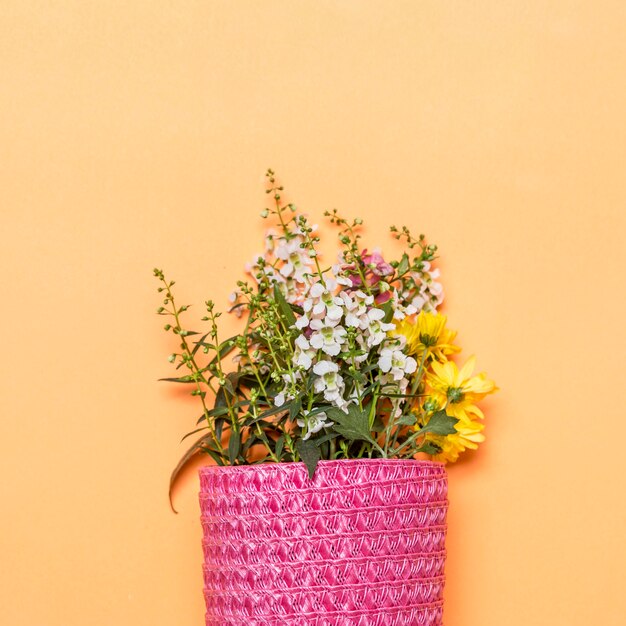 Bouquet of wild flowers in pink bag