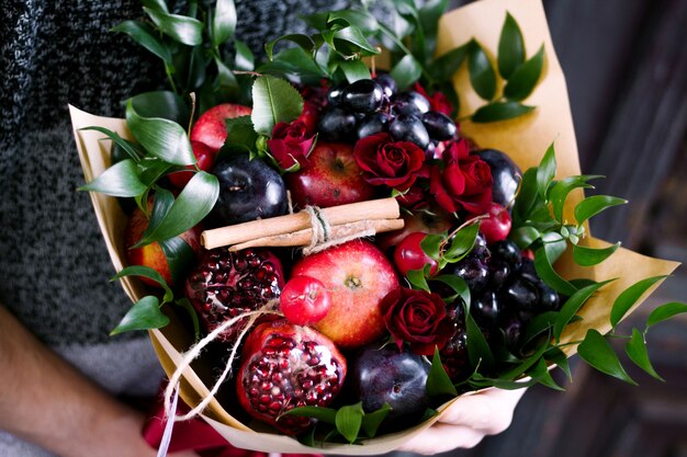 Bouquet with fruits and roses