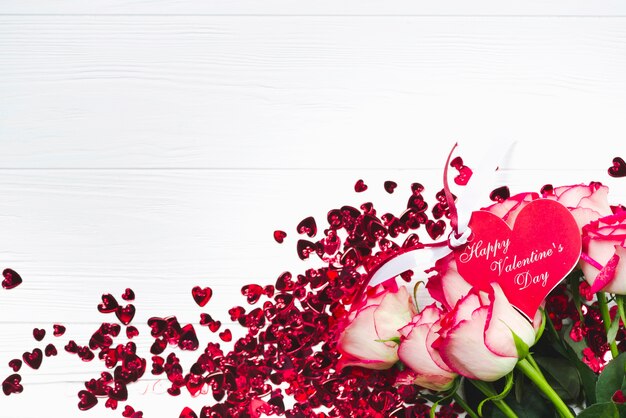 Bouquet with greeting card on confetti