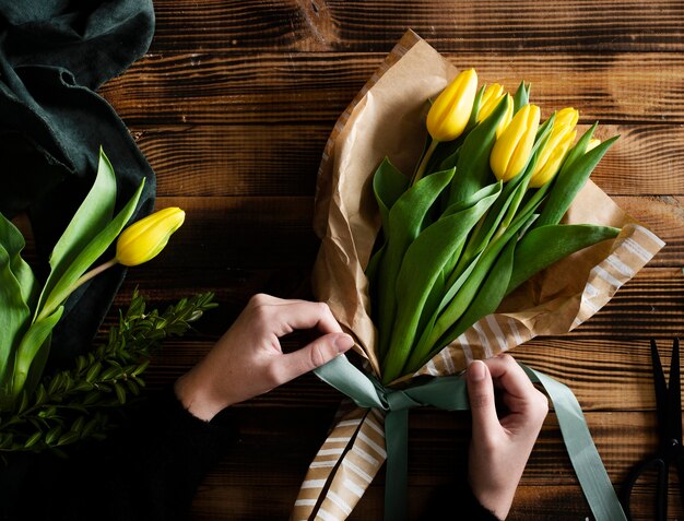 Bouquet of yellow tulips on table