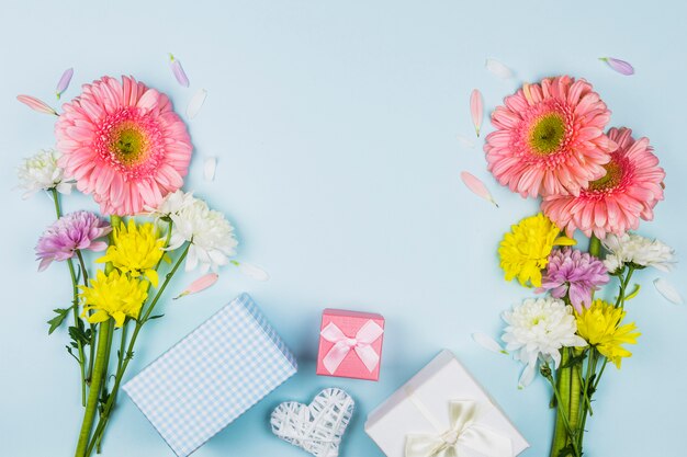 Bouquets of fresh flowers near present boxes