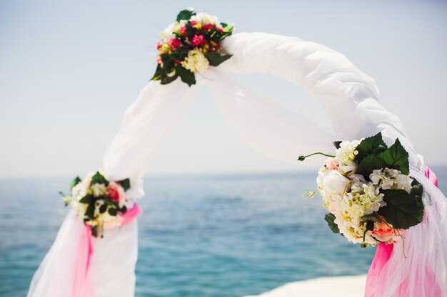 Bouquets of white flowers decorate a wedding altar