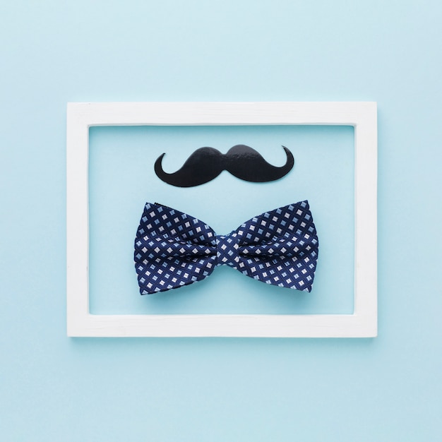 Bow and moustache on blue background