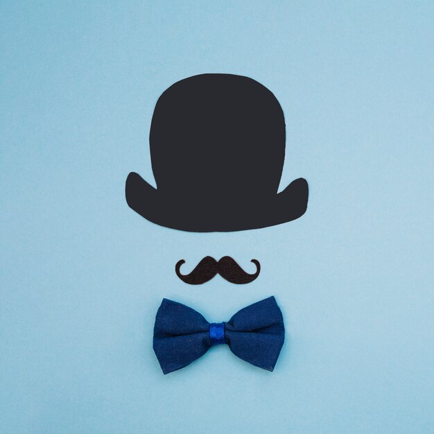 Bow tie near ornamental mustache and top hat