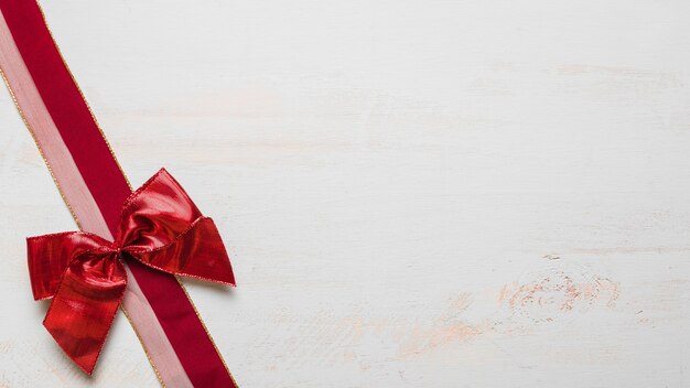 Bow and two-colored ribbon on white table