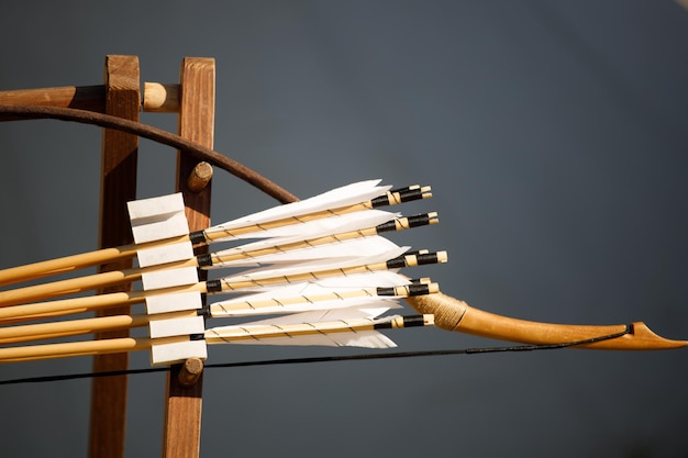 Bow with arrows on a gray background. close-up