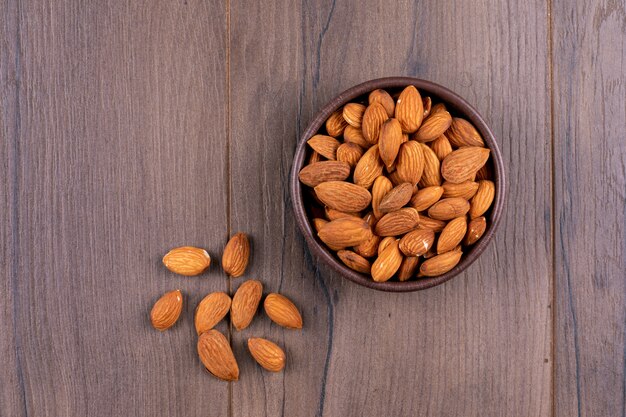 A bowl of almond top view on a wooden table