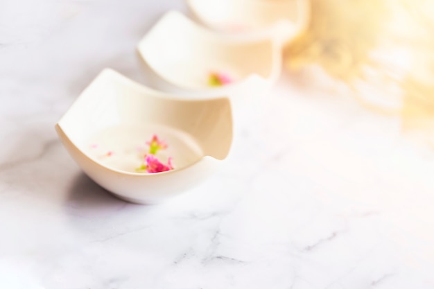 Bowl of aroma spa water arranged in a row