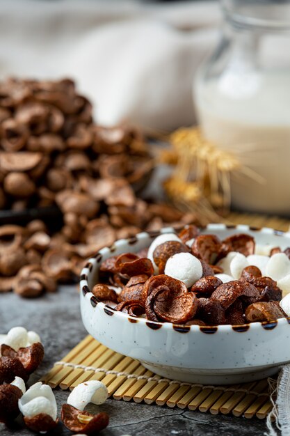 A bowl of cereal, chocolate-flavored cereal mixed with milk for breakfast.