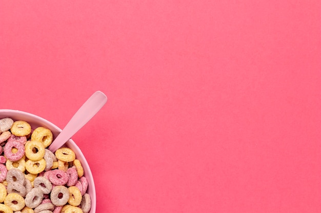 Bowl of cereal fruit loops with spoon in the corner