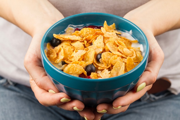 Foto gratuita ciotola di cereali nella mano della donna