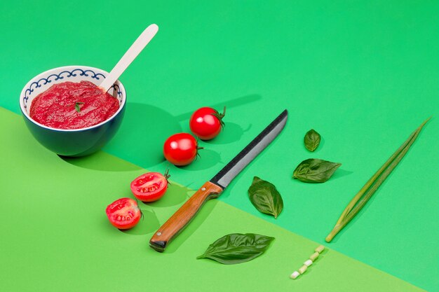 Bowl of chopped tomatoes on green table