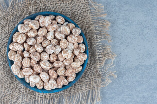 A bowl of confectionery on the marble table. 