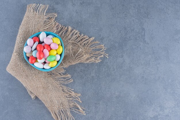 A bowl of cookies on the towel, on the marble background. 