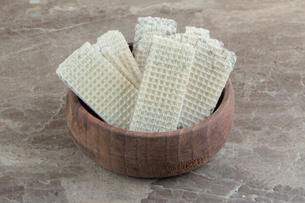 Bowl of crispy waffles on marble surface