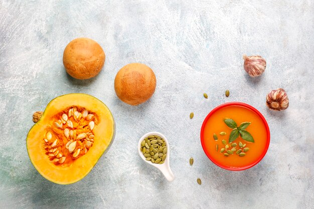 Bowl of delicious pumpkin soup with seeds.