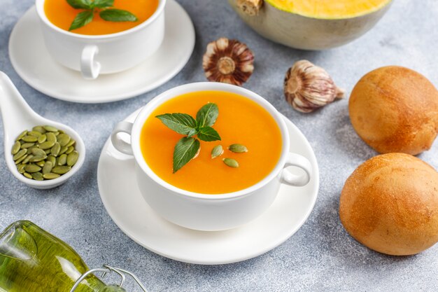 Bowl of delicious pumpkin soup with seeds.