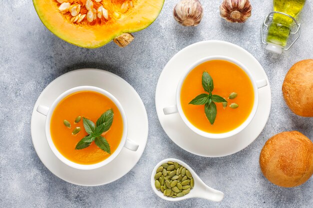 Bowl of delicious pumpkin soup with seeds.