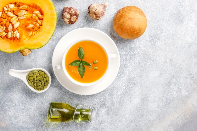 Bowl of delicious pumpkin soup with seeds.