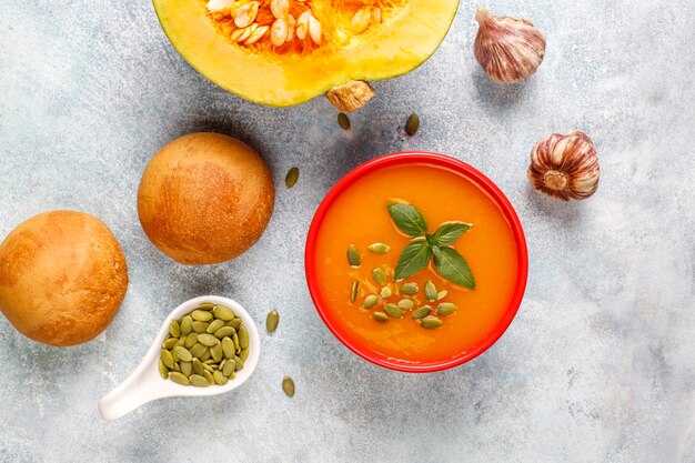 Bowl of delicious pumpkin soup with seeds.