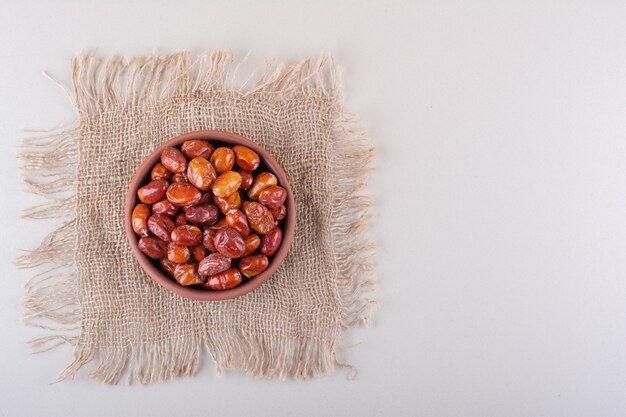 Bowl of dried delicious silverberries placed on white background. High quality photo