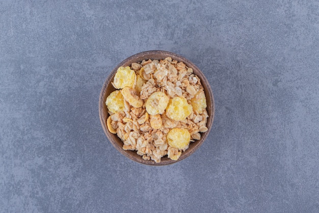 A bowl of flavorful muesli , on the marble background.