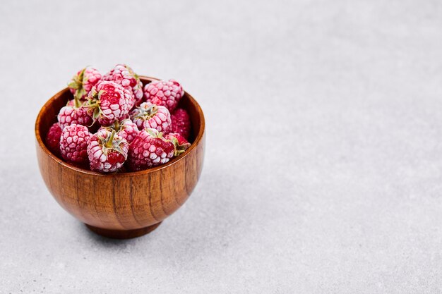 Bowl of fresh red raspberries on white background. 